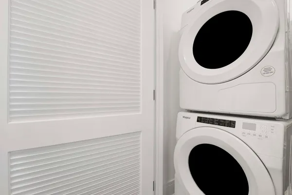 a close view of a utility room with dryer and washer