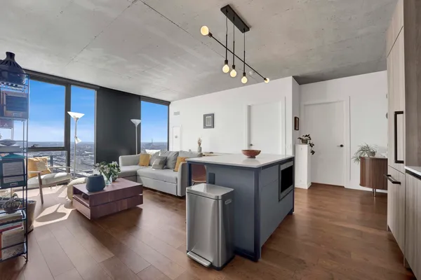 a living room with furniture and a wooden floor