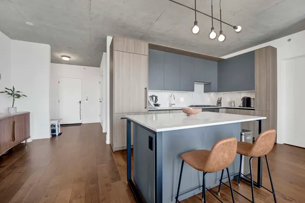 a kitchen with a dining table chairs refrigerator and cabinets