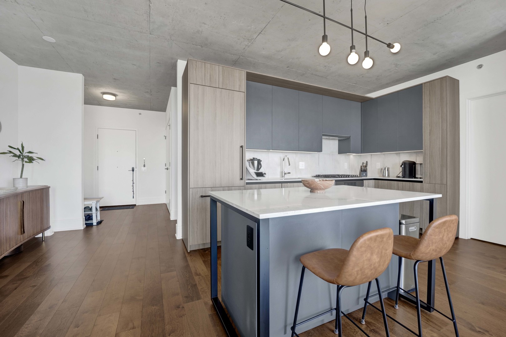 234 West Polk Street, Unit 2903 Chicago, IL 60607 - Photo 10 of 39 a kitchen with a dining table chairs refrigerator and cabinets