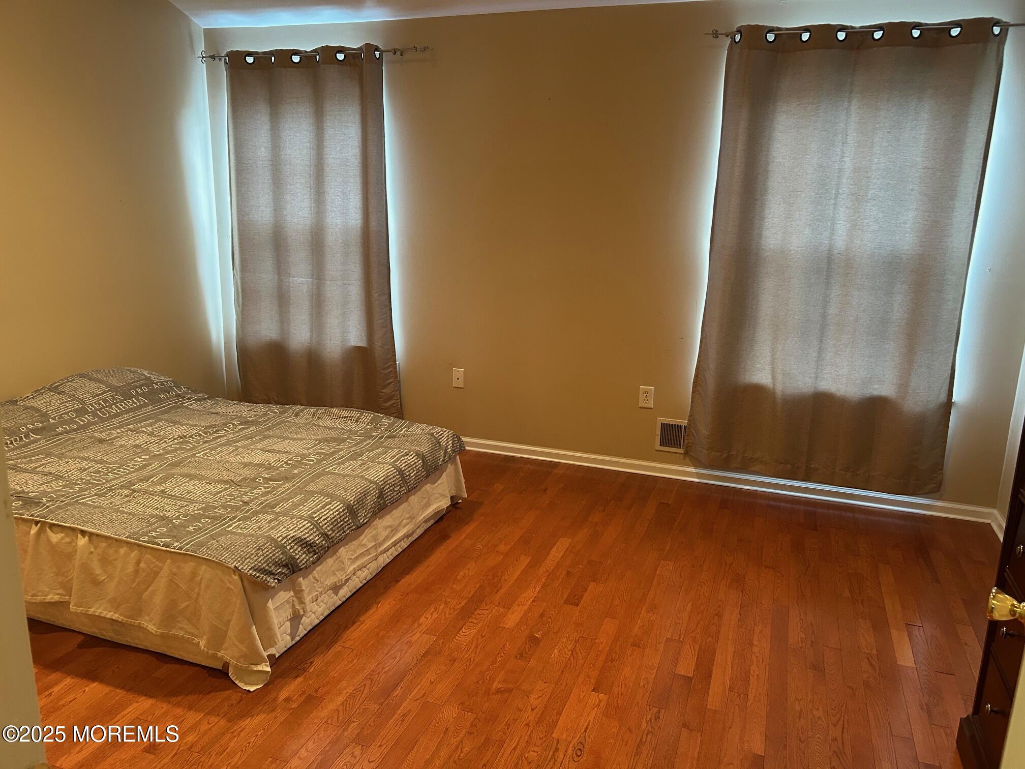 319 Bernard Drive Morganville, NJ 07751 - Photo 14 of 32 a bedroom with a bed and a mirror