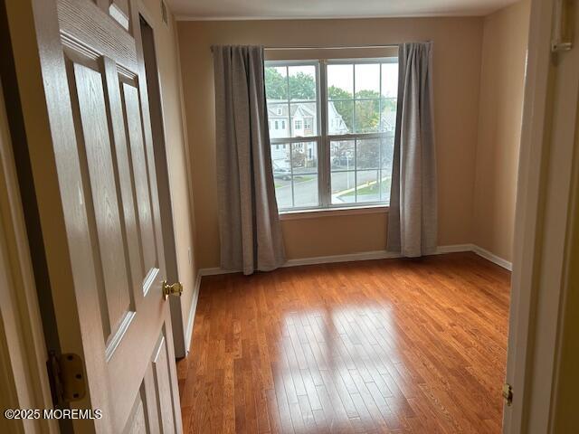 319 Bernard Drive Morganville, NJ 07751 - Photo 18 of 32 a view of an empty room with wooden floor and a window