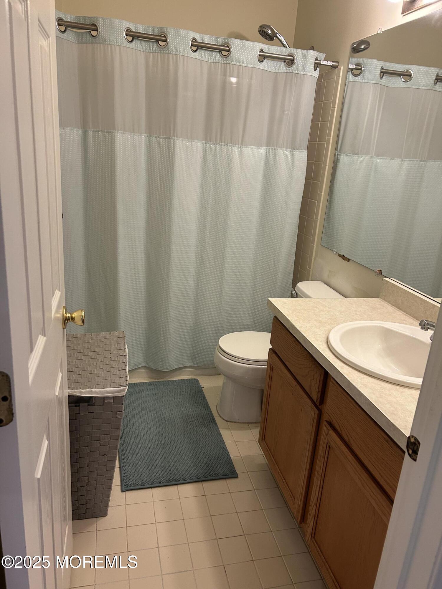 319 Bernard Drive Morganville, NJ 07751 - Photo 22 of 32 a bathroom with a sink a toilet and shower