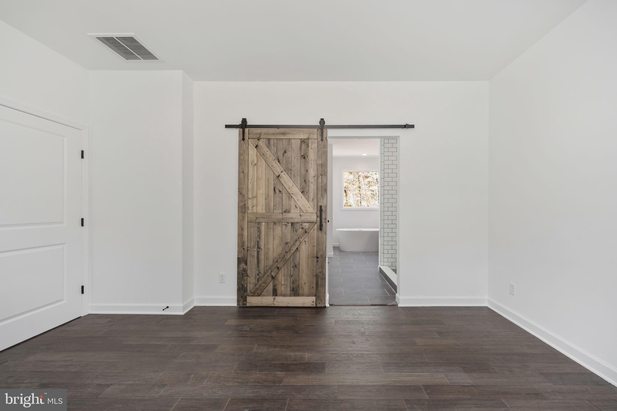 Hunters Ridge Lane Unionville, VA 22567 - Photo 11 of 33 a view of an empty room with wooden floor and a window