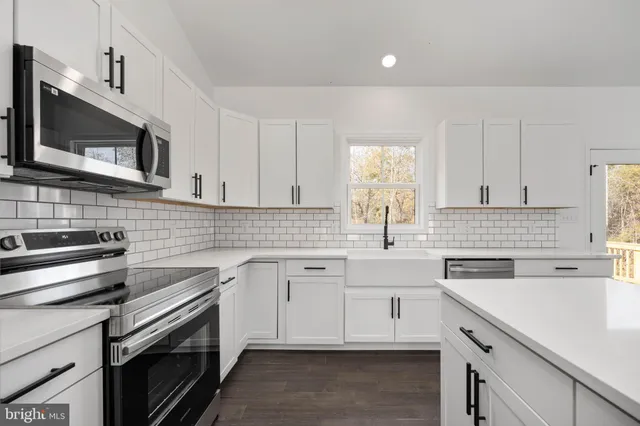 a kitchen with a sink stove and microwave