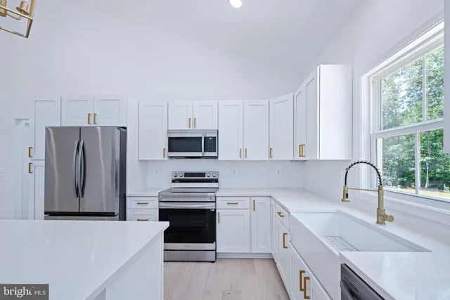 a kitchen with stainless steel appliances a refrigerator sink and cabinets