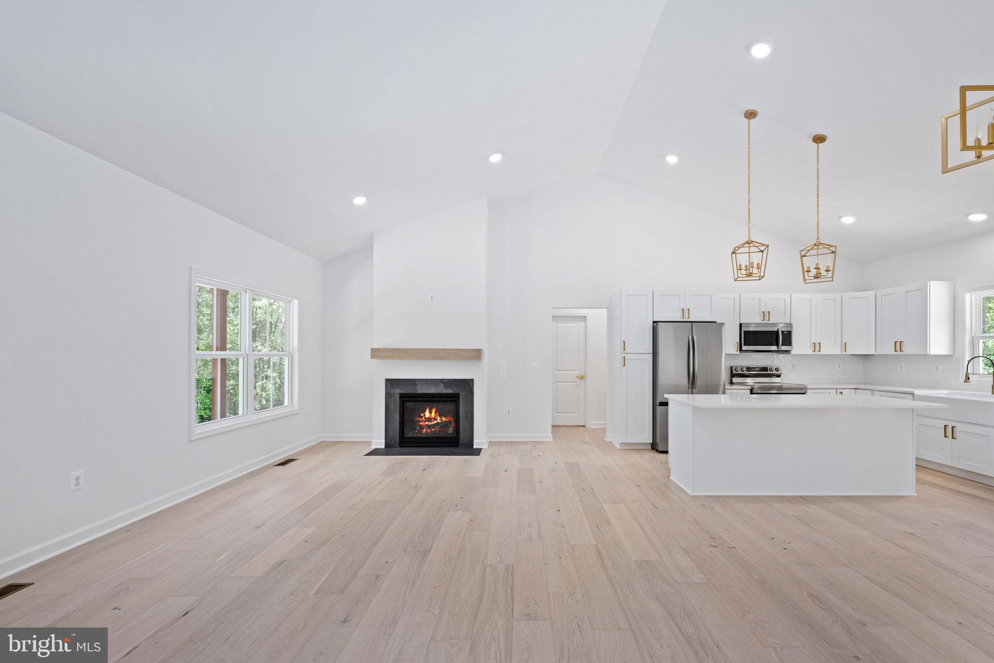 Hunters Ridge Lane Unionville, VA 22567 - Photo 8 of 33 a open kitchen with white cabinets and a fireplace
