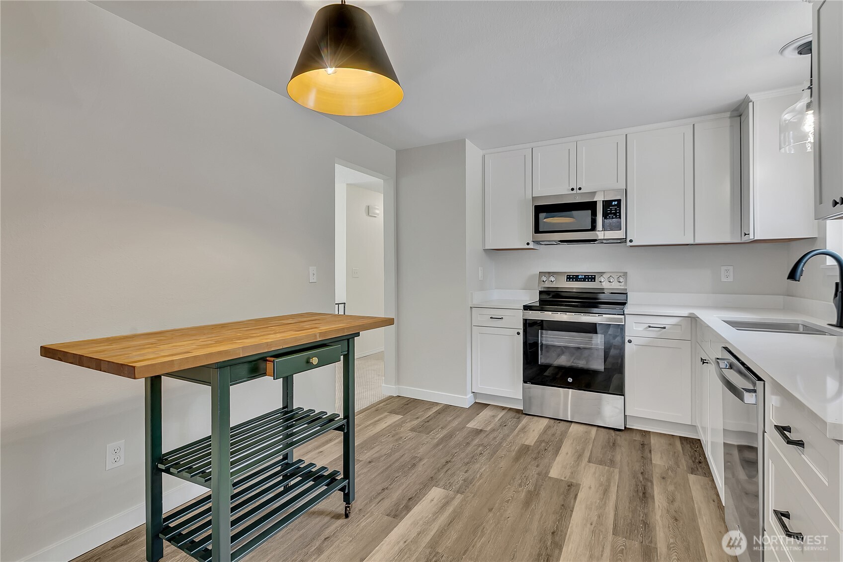 46 Ira Light Street Steilacoom, WA 98388 - Photo 13 of 35 a kitchen with stainless steel appliances a stove a sink and a microwave