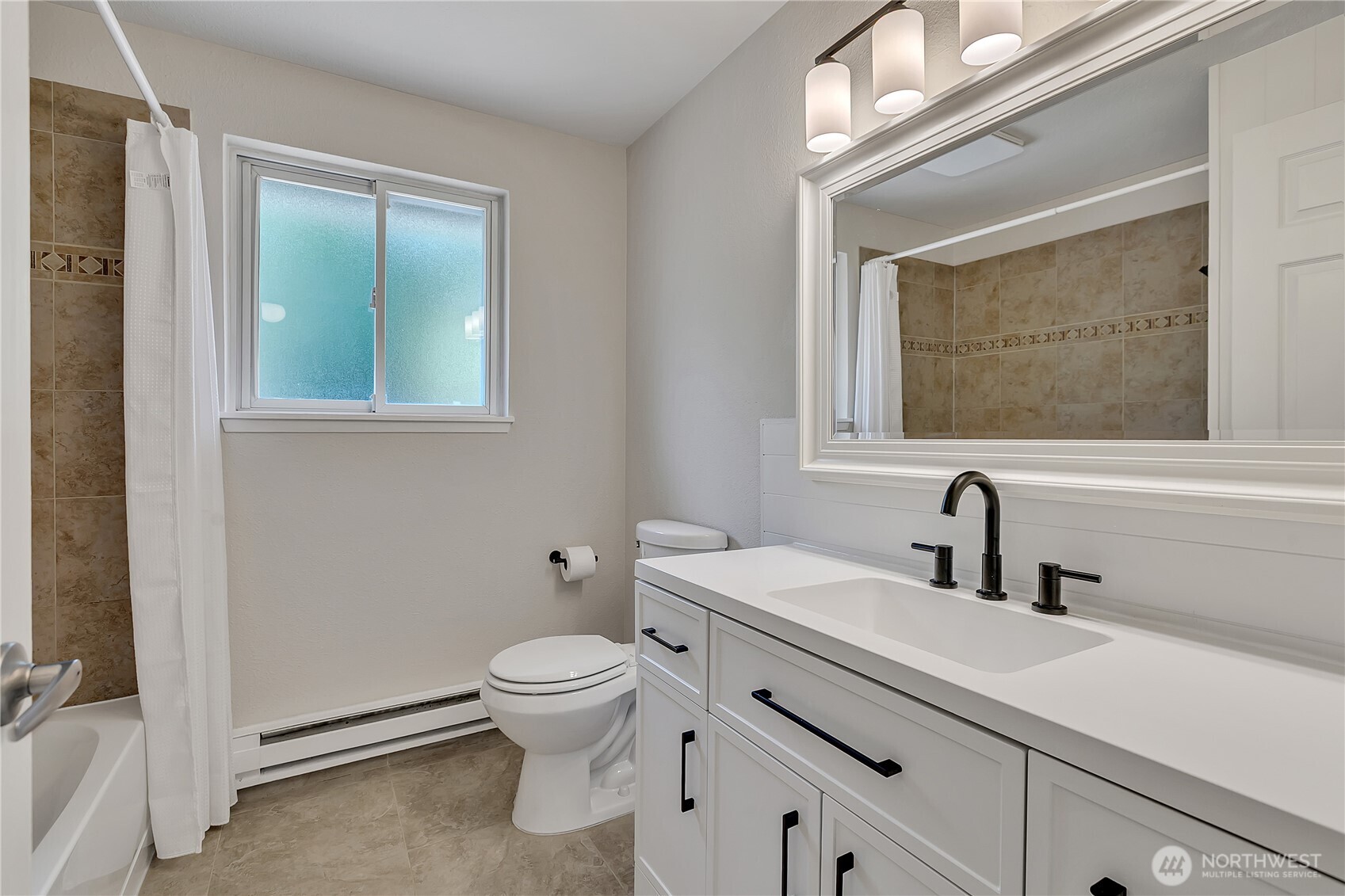 46 Ira Light Street Steilacoom, WA 98388 - Photo 18 of 35 a bathroom with a sink a mirror and a toilet