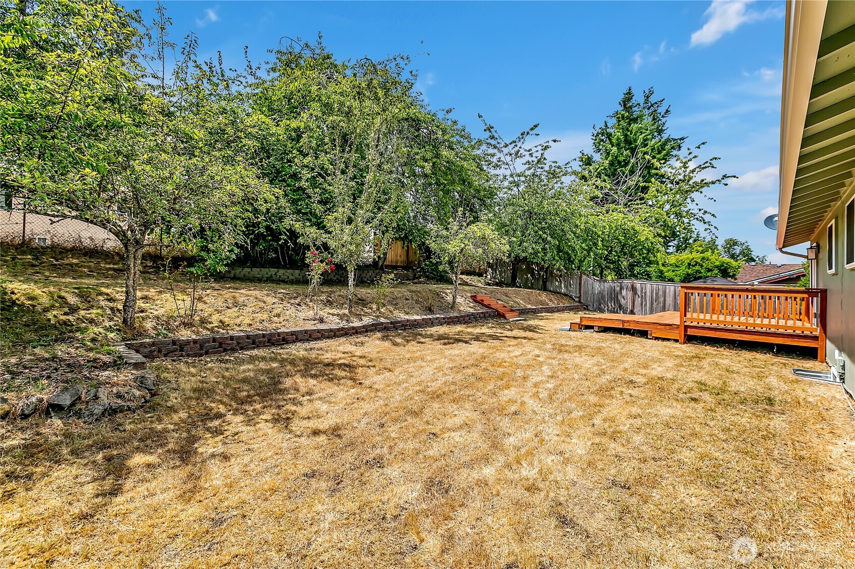 46 Ira Light Street Steilacoom, WA 98388 - Photo 28 of 35 a backyard of a house with trees and outdoor seating