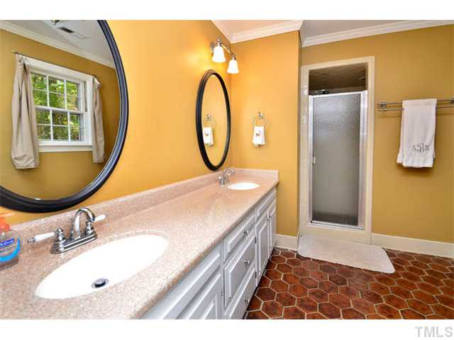 7201 Grist Mill Road Raleigh, NC 27615 - Photo 12 of 25 a bathroom with a sink and a mirror