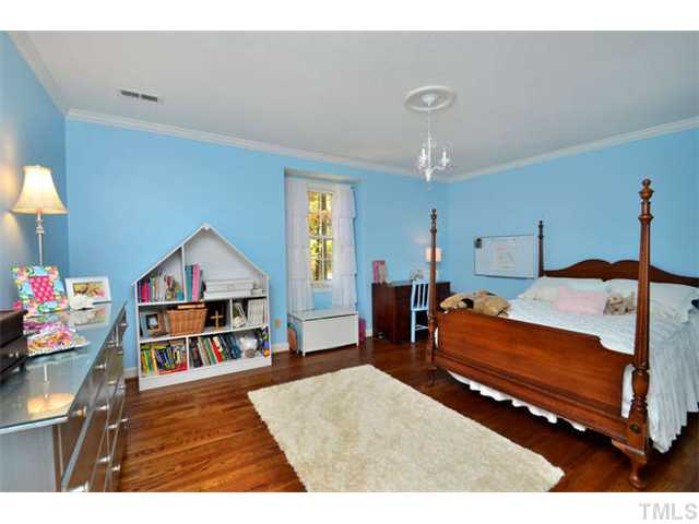 7201 Grist Mill Road Raleigh, NC 27615 - Photo 14 of 25 a bedroom with furniture and a book shelf