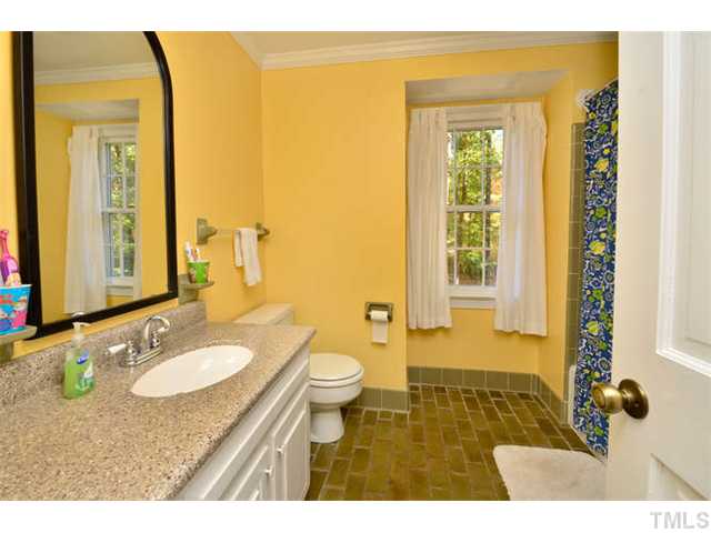 7201 Grist Mill Road Raleigh, NC 27615 - Photo 15 of 25 a bathroom with a granite countertop sink toilet and shower