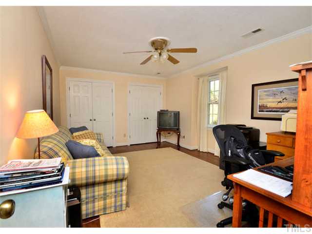 7201 Grist Mill Road Raleigh, NC 27615 - Photo 17 of 25 a bedroom with bed and chair