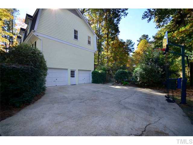 7201 Grist Mill Road Raleigh, NC 27615 - Photo 24 of 25 a view of a house with a yard