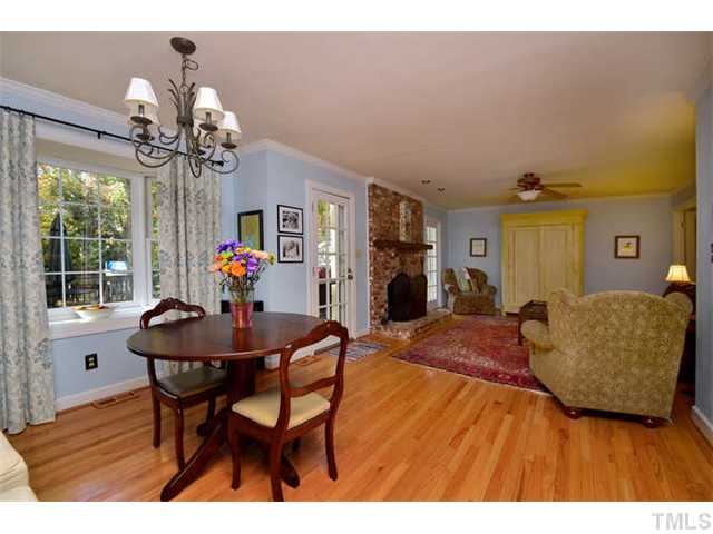 7201 Grist Mill Road Raleigh, NC 27615 - Photo 10 of 25 a view of a dining room with furniture and a chandelier