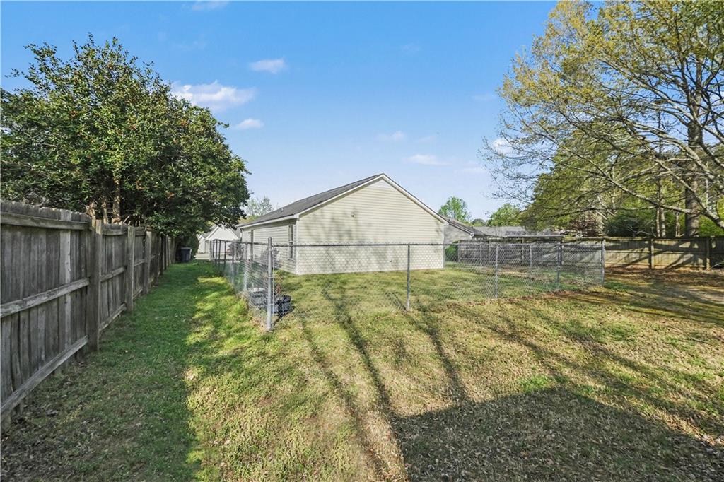 280 Courtyard Circle Winder, GA 30680 - Photo 19 of 24 a view of backyard with green space and wooden fence