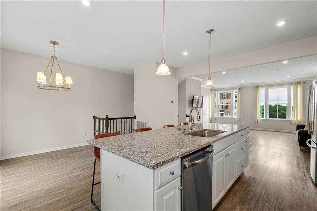152-160 Cole Drive McKees Rocks, PA 15136 - Photo 11 of 39 a kitchen with a center island wooden floor and a chandelier