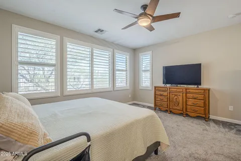 a bedroom with a bed and a tv