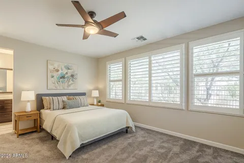a bedroom with a large bed and a large window