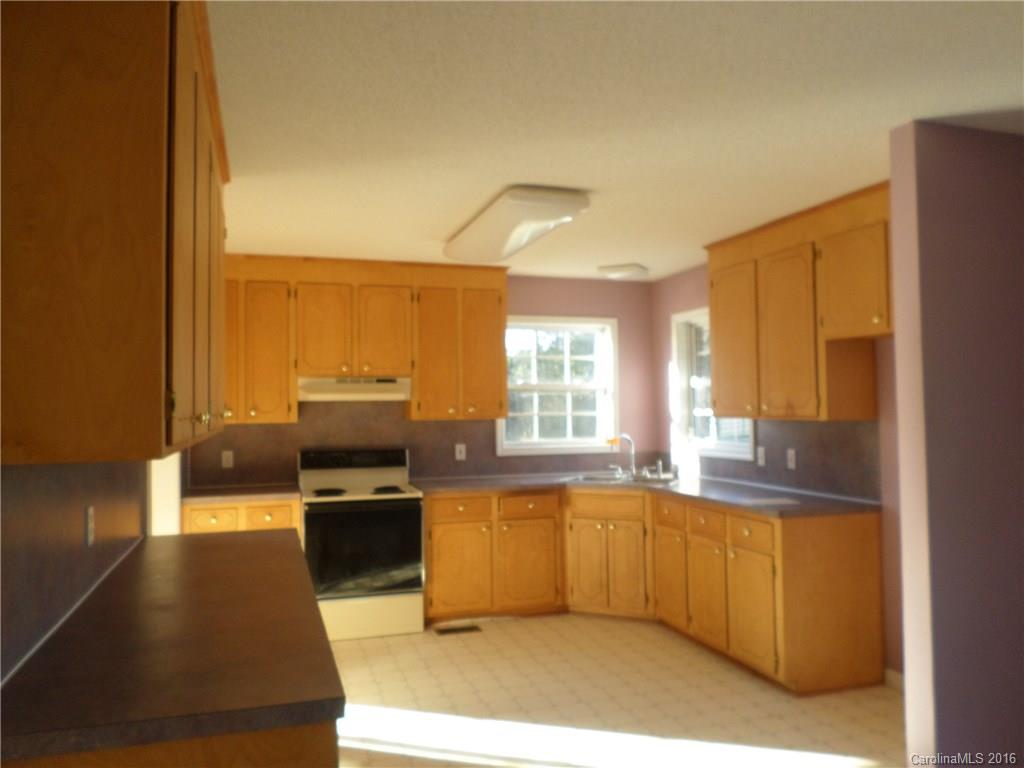 2680 Cassel's Road Chester, SC 29706 - Photo 4 of 22 a kitchen with stainless steel appliances granite countertop a stove a sink and a refrigerator with wooden floor