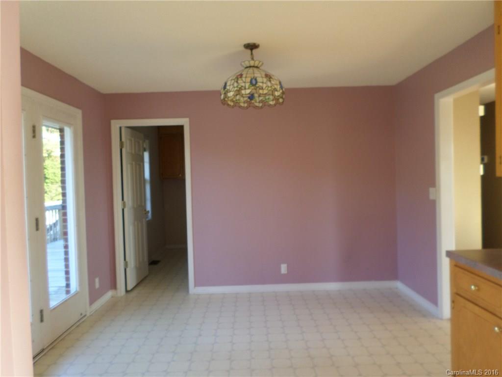 2680 Cassel's Road Chester, SC 29706 - Photo 6 of 22 an empty room with kitchen view and wooden floor