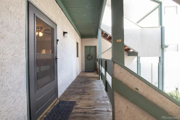 a view of a hallway with wooden floor and staircase
