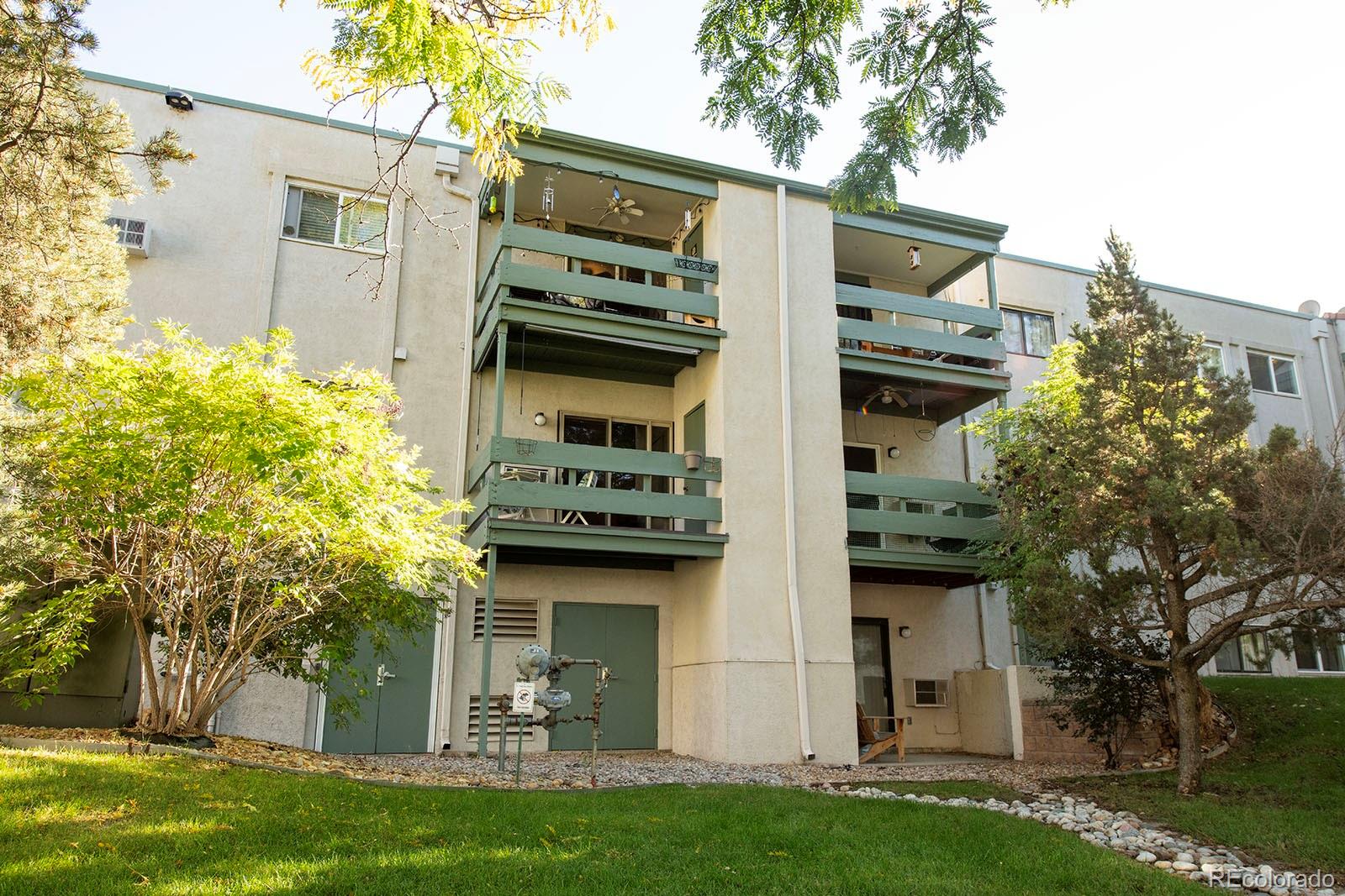 7740 West 35th Avenue, Unit 207 Wheat Ridge, CO 80033 - Photo 16 of 18 a view of a house with a yard and plants