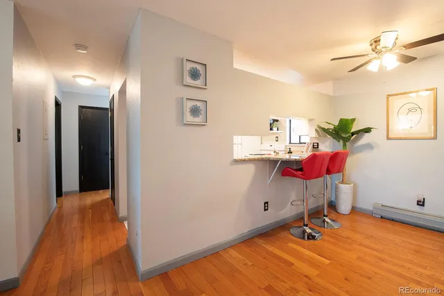 a room with gym equipment and wooden floor
