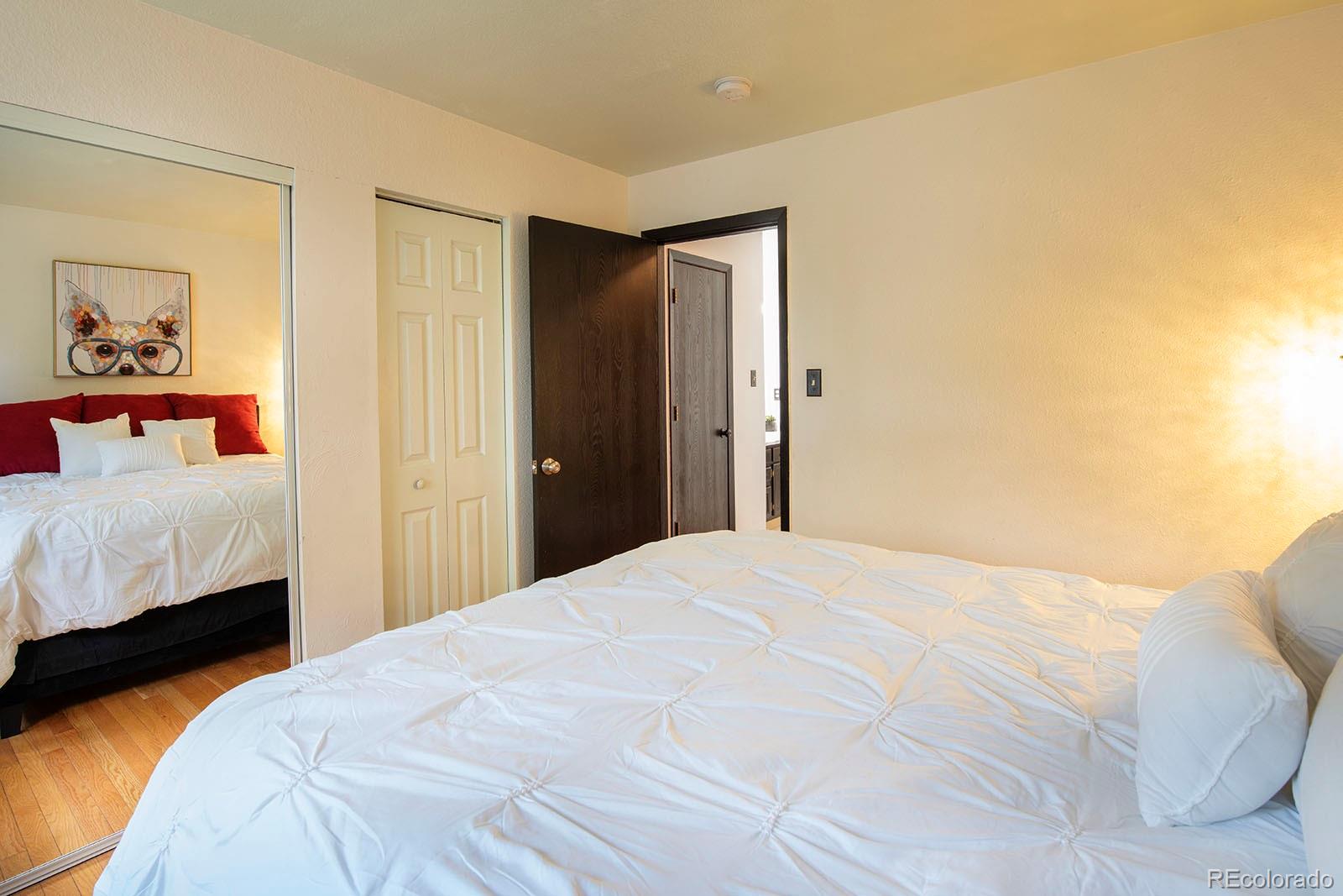 7740 West 35th Avenue, Unit 207 Wheat Ridge, CO 80033 - Photo 9 of 18 a bedroom with a bed and a window