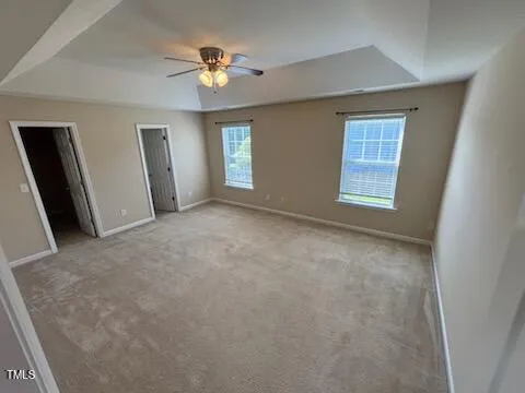 an empty room with windows and closet