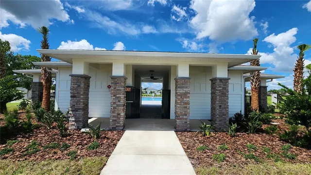 a front view of a house with a lots of potted plants