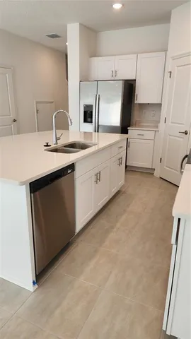 a kitchen with cabinets a sink and appliances