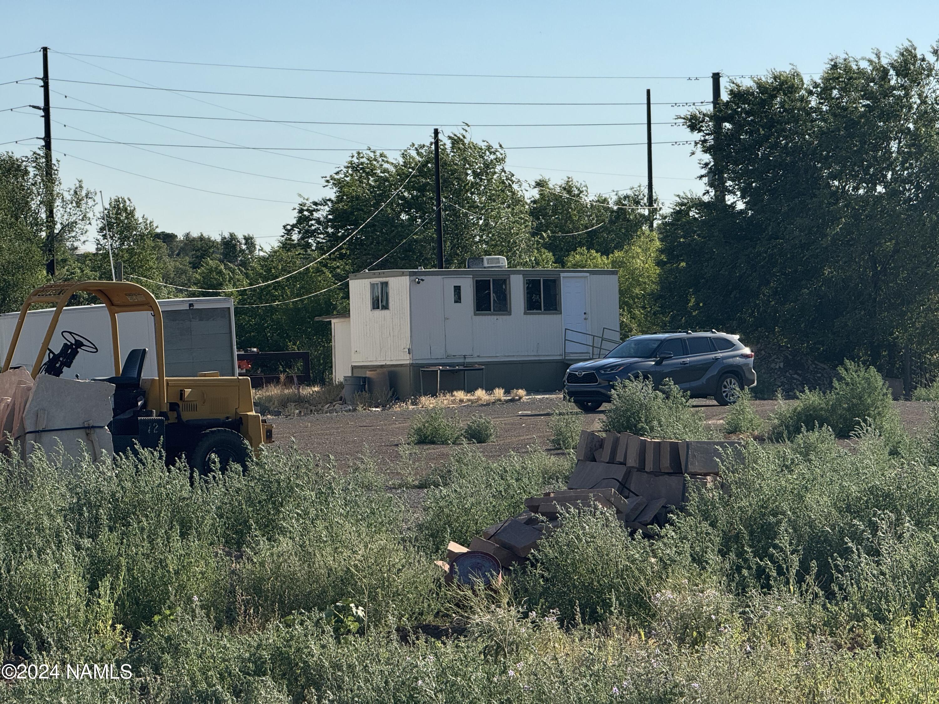 48501 North Double A Rnch Road Williams, AZ 86046 - Photo 11 of 46 a backyard of a house with barbeque oven and outdoor seating