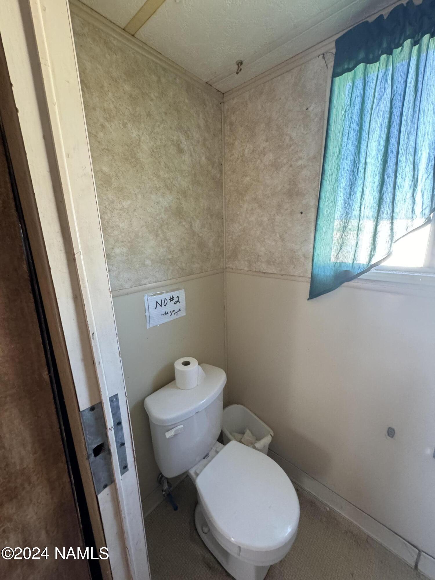 48501 North Double A Rnch Road Williams, AZ 86046 - Photo 15 of 46 a white toilet sitting next to a small window