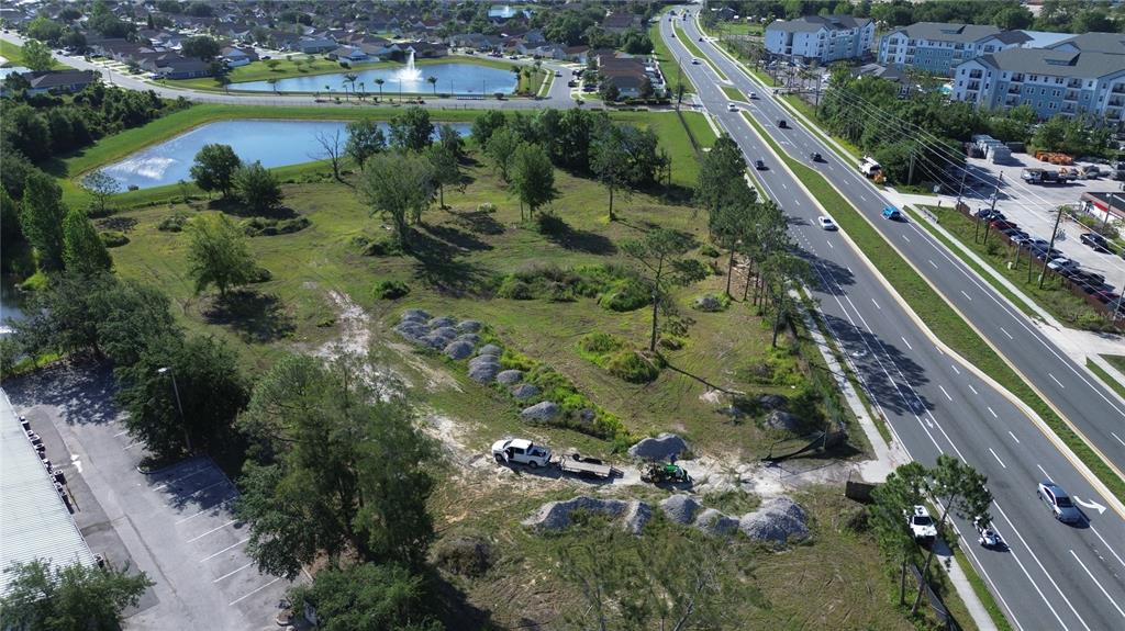 6347 Narcoossee Road Orlando, FL 32822 - Photo 14 of 17 an aerial view of residential houses with outdoor space and lake view