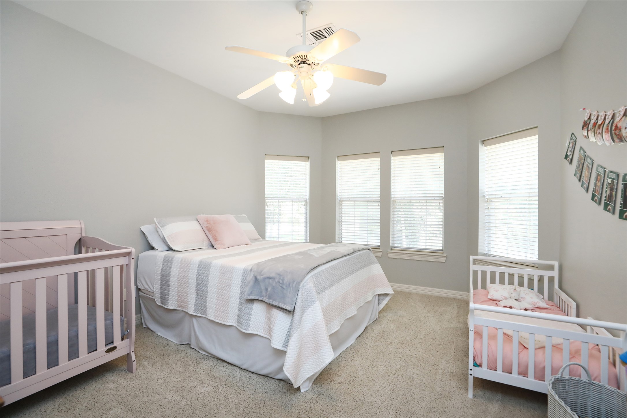 12126 Zion Road Tomball, TX 77375 - Photo 26 of 45 a spacious bedroom with a bed and a chandelier