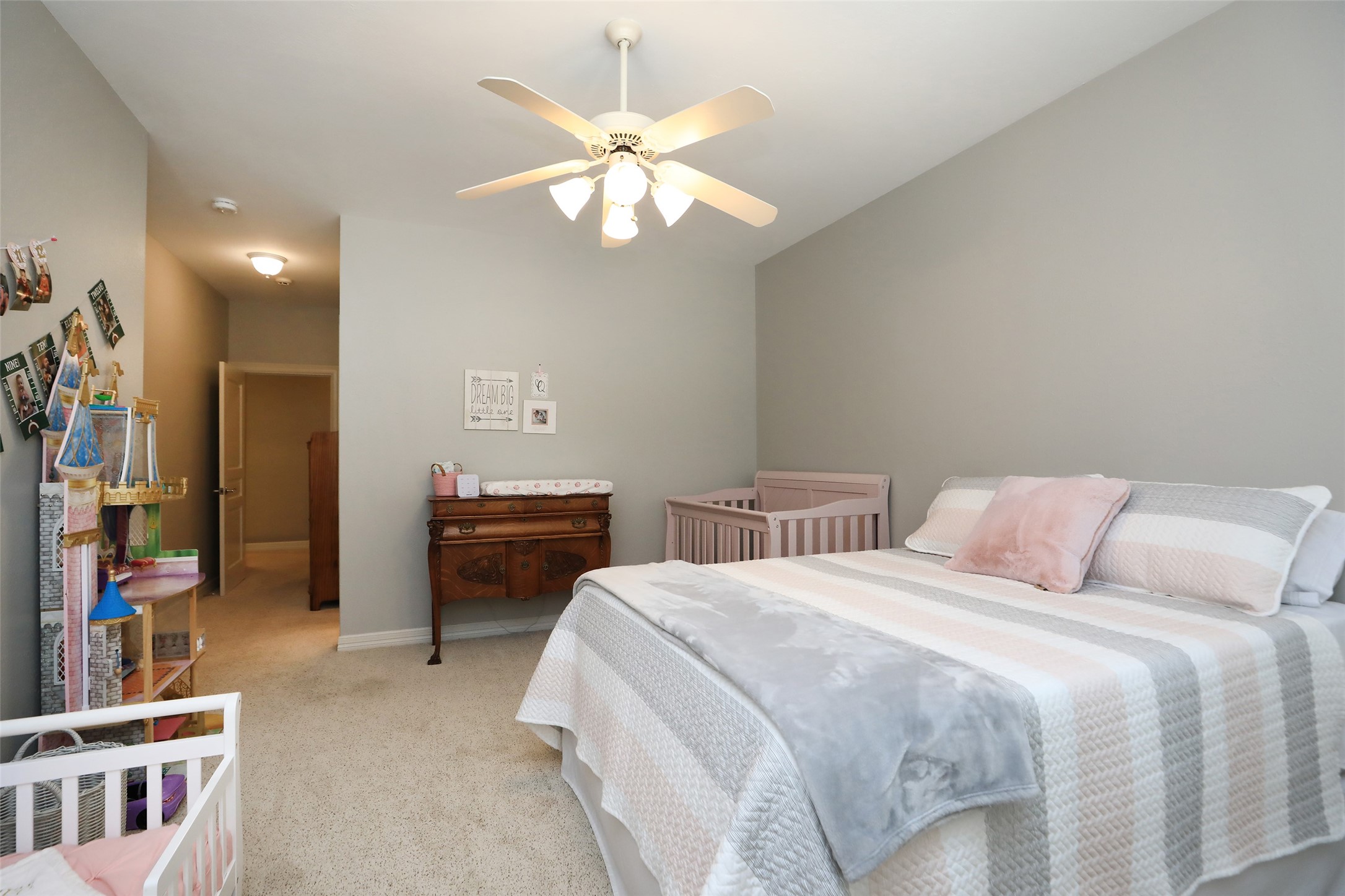 12126 Zion Road Tomball, TX 77375 - Photo 27 of 45 a bedroom with a bed and a chandelier