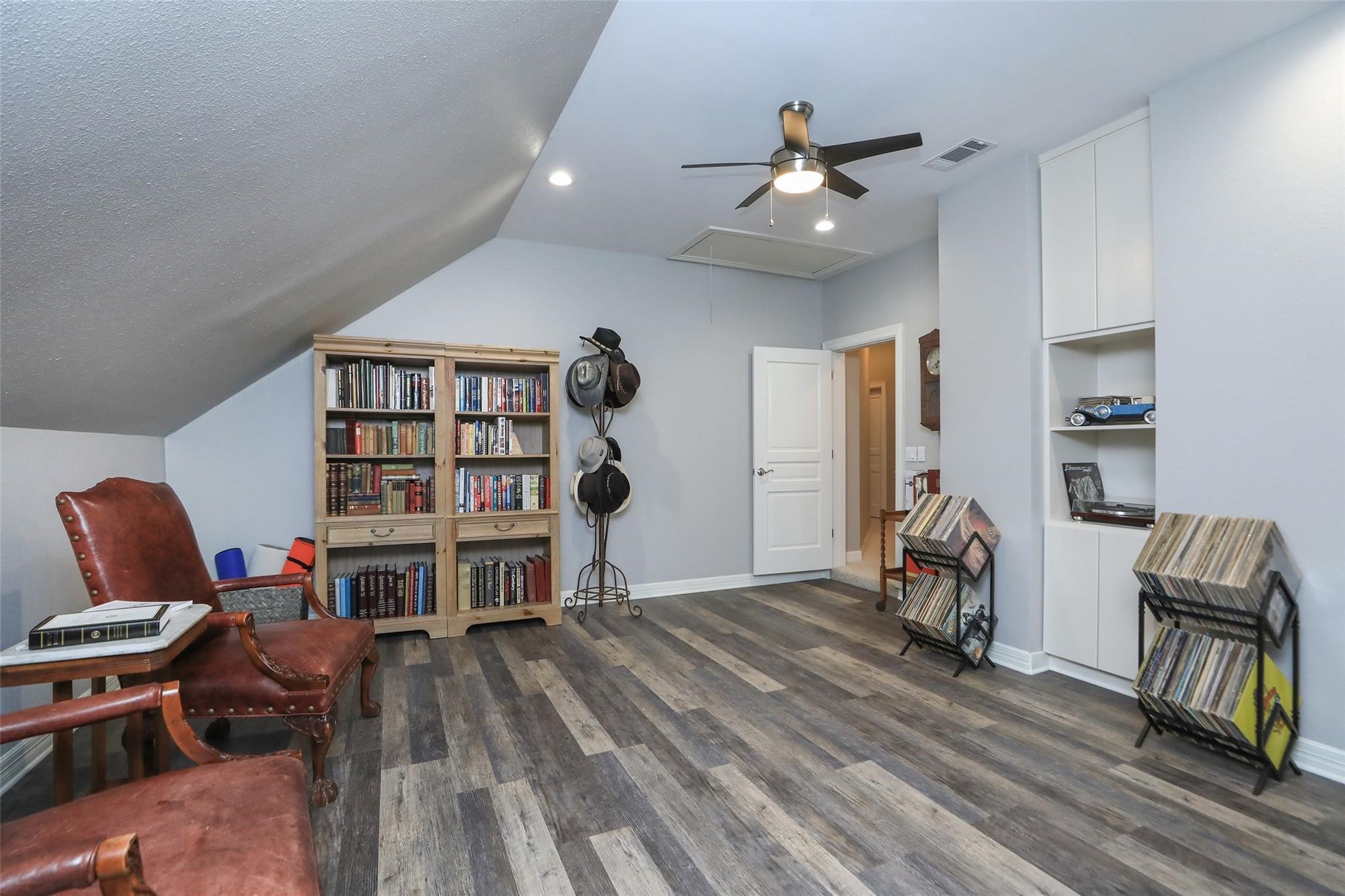12126 Zion Road Tomball, TX 77375 - Photo 28 of 45 a living room with furniture a piano and a bookshelf