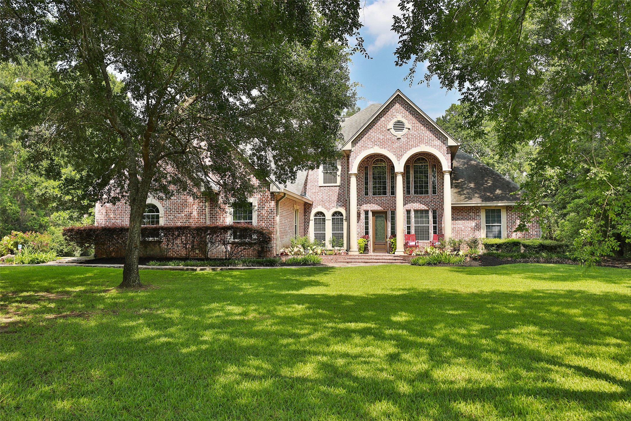 12126 Zion Road Tomball, TX 77375 - Photo 6 of 45 a front view of a house with a yard and trees
