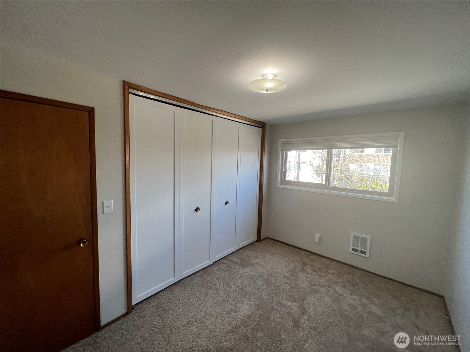 1505 East Galer Street, Unit 3 Seattle, WA 98112 - Photo 6 of 9 a view of an empty room with a window