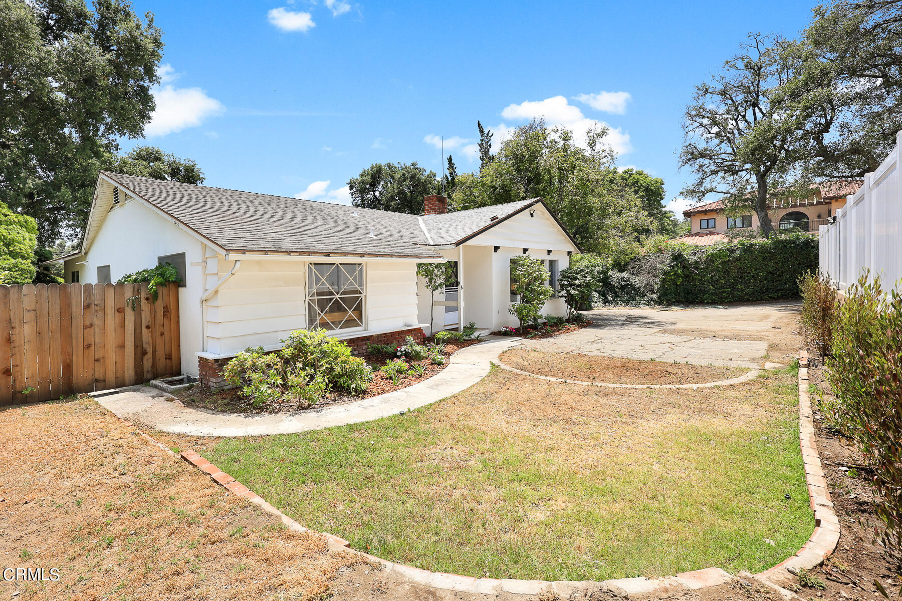 636 Knight Way La Canada Flintridge, CA 91011 - Photo 2 of 44 a view of a white house with a small yard and wooden fence