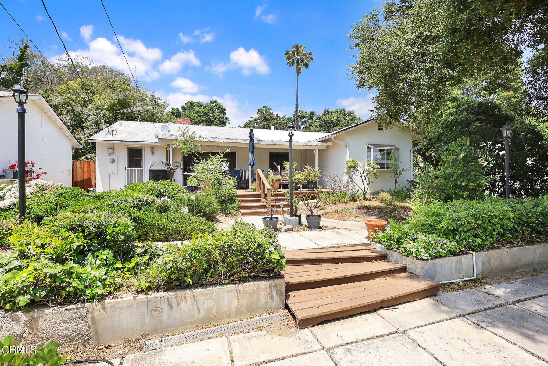 636 Knight Way La Canada Flintridge, CA 91011 - Photo 27 of 44 a view of a patio with table and chairs potted plants and large tree