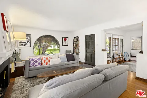 a living room with furniture or couch and a wooden floor