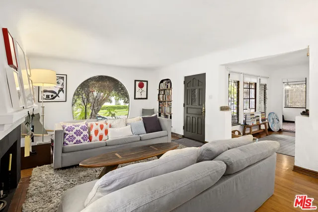 a living room with furniture or couch and a wooden floor