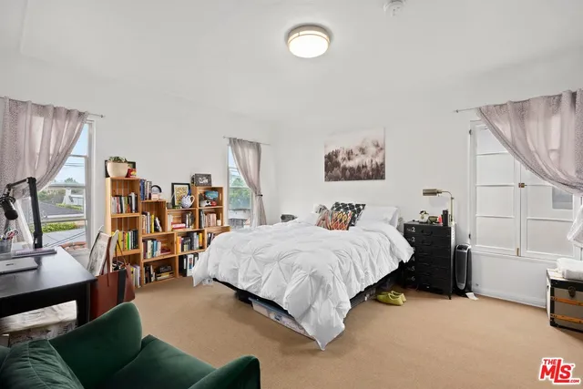 a bedroom with a bed and dresser