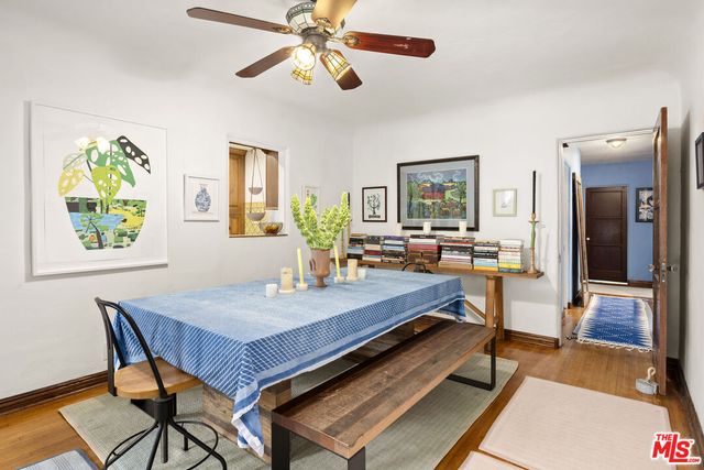 a living room with dining table and wooden floor