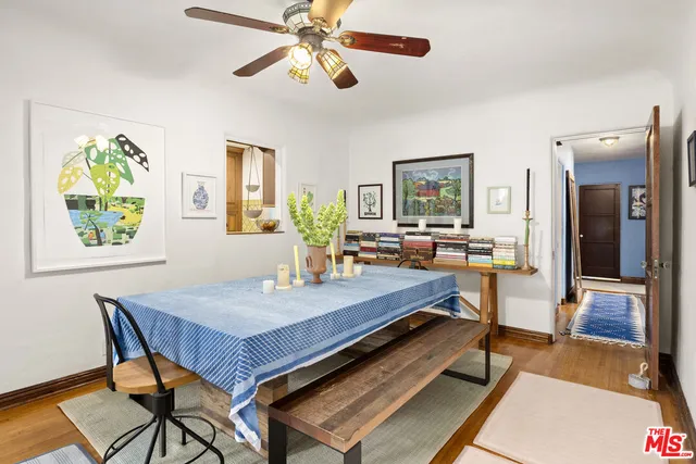 a living room with dining table and wooden floor