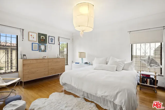 a bedroom with a bed and a chandelier