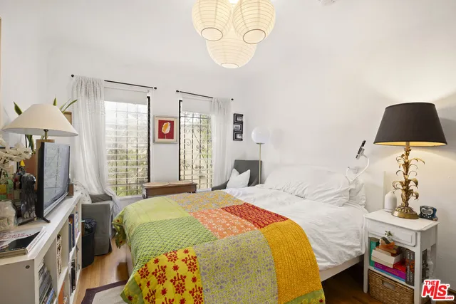 a bedroom with a bed and a flat screen tv